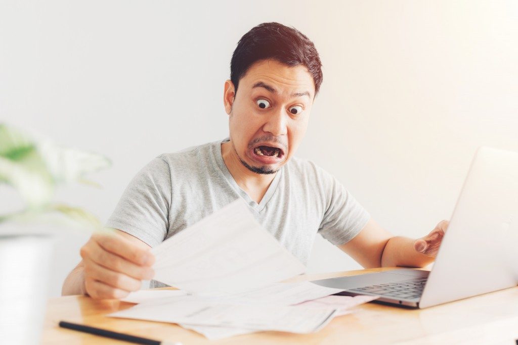 Shocked man bills and debts